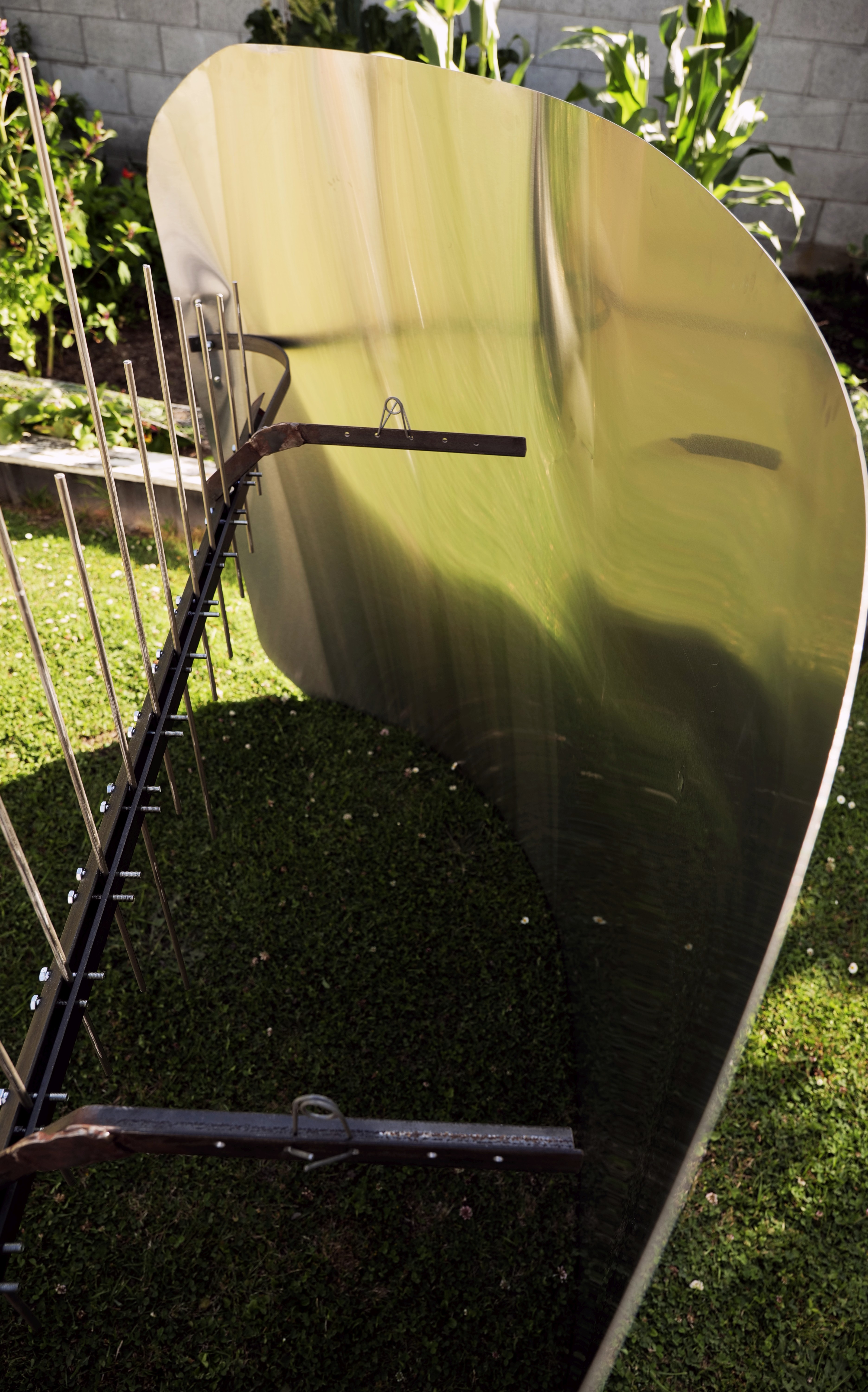 The Space Bass is on a small grassed area. It is not on its stand but is just resting on the ground.