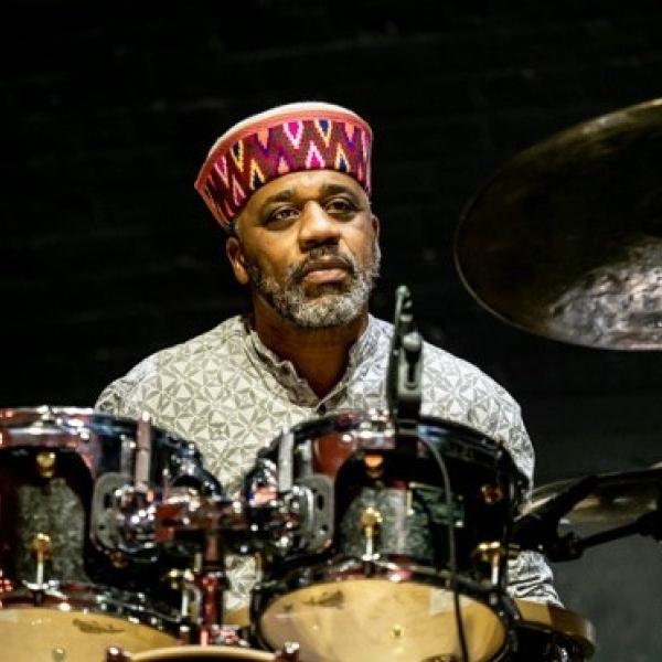 a colour photo of Pheeroan playing drums