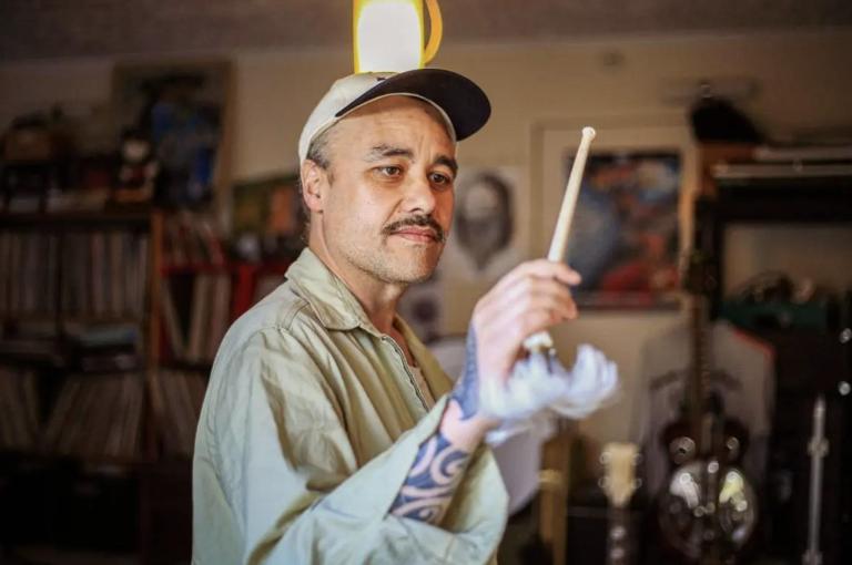 A photo of Riki Pirihi holding a drum stick 